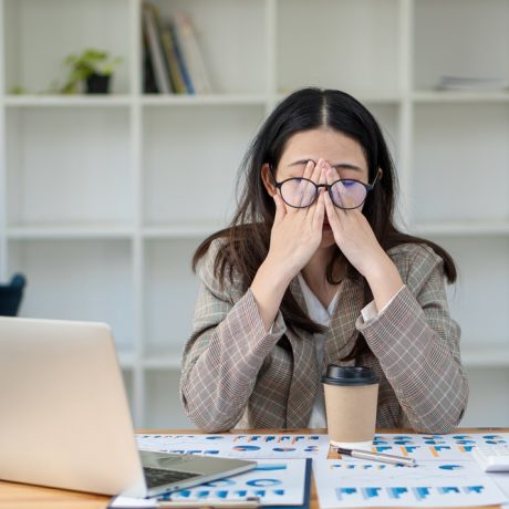 A,Tired,Asian,Businesswoman,Appears,To,Be,So,Sleepy,That