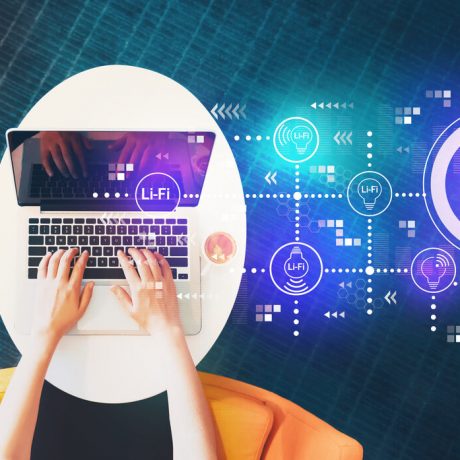 LiFi theme with person using a laptop LiFi theme with person using a laptop on a white table