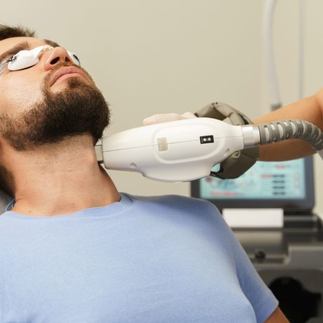 Man during beard photoepilation procedure Man during beard photoepilation procedure in aesthetic medical clinic